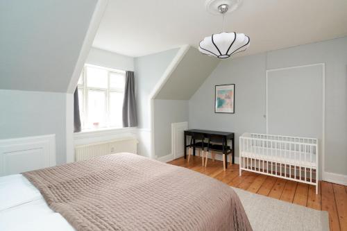 a bedroom with a bed and a desk at Stylish 5 Person Flat in Vibrant Urban Area in Copenhagen