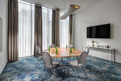 a conference room with a table and chairs and a tv at Quality Hotel Brno Exhibition Centre in Brno