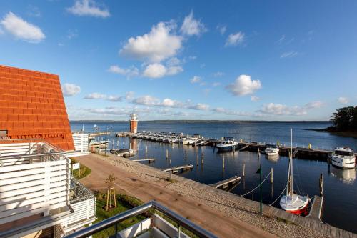 a marina with boats in the water next to a building at Becci's Apartment P6A8 in Plau am See