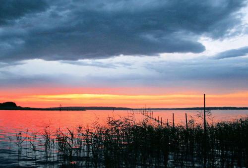 a sunset over a large body of water at Leuchtturmblick Haus 6 A 5 in Plau am See