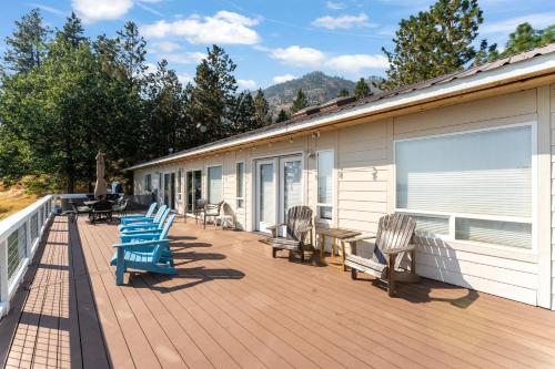 a deck with chairs and tables and a building at Blue Lake Serenity in Hollywood Beach