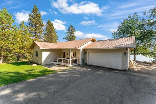 a house with a garage and a driveway at Blue Lake Serenity in Hollywood Beach