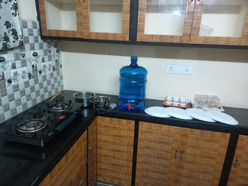 a kitchen counter with a large bottle of water on it at ADVIK HOMESTAYS in Tirupati