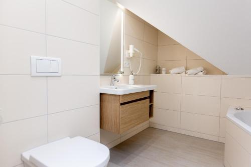 a white bathroom with a sink and a toilet at Apartment mit 3 Schlafzimmer P5A7 in Plau am See