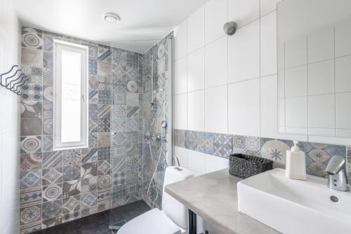a bathroom with a sink and a toilet at Villa Jokivarsi Bed & Breakfast in Vantaa