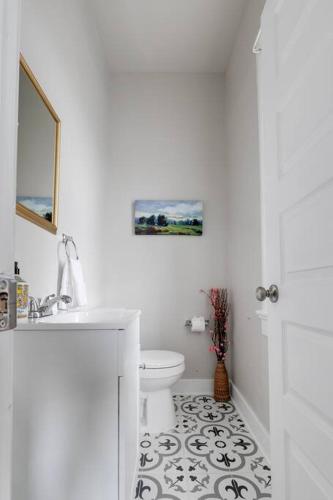 a white bathroom with a toilet and a sink at G5 KING BED central location museums FREE PARKING in Richmond