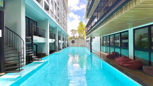 a swimming pool in the middle of a building at Tour De Phuket Hotel - SHA Plus in Thalang