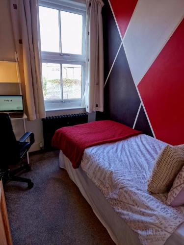 a bedroom with a bed and a window at The Nook Cosby Village in Cosby