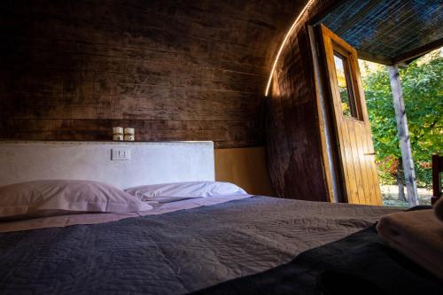 a bedroom with a large bed with a window at Albavillage Hotel Wellness & Camping in Alba