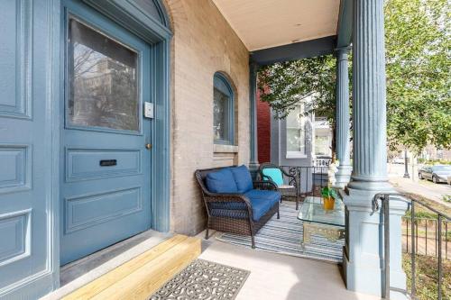 a front porch with a blue door and a chair at G7 central location museums free parking in Richmond
