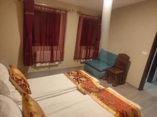 a living room with a couch and a chair at Sun-House Pension&Restaurant -ParkingFree- in Prague