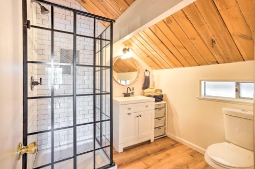 a bathroom with a toilet and a glass shower door at Dreamy Big Bear Home with Wood Stove and Grill in Big Bear Lake