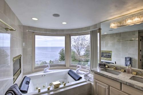 a large bathroom with a large tub and a large window at Grand Egg Harbor Home with Stunning Lake Views! in Egg Harbor