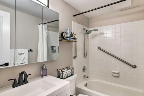 La salle de bains est pourvue d'une baignoire blanche, d'un lavabo et de toilettes. dans l'établissement Modern Anchorage Apartment Near Hospitals!, à Anchorage