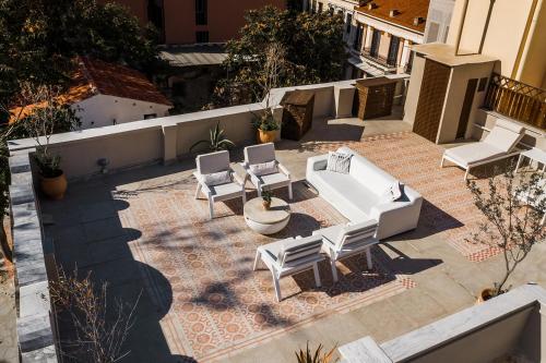 an aerial view of a patio with chairs and a couch at The Hadrian Wall - A Historic Acropolis Villa in Athens