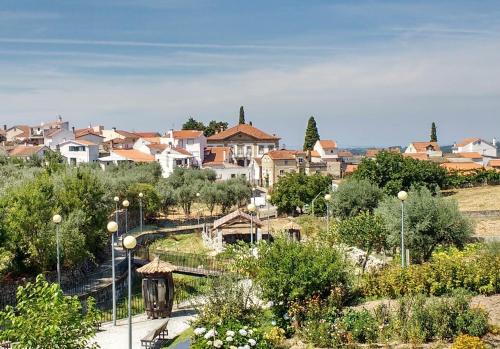 a town with houses on a hill with trees at Casa Grande - Casas de Campo na Serra da Estrela in Paços da Serra
