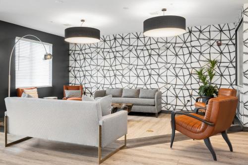 a living room with a couch and a chair at WaterWalk Extended Stay by Wyndham Minneapolis - Plymouth in Plymouth