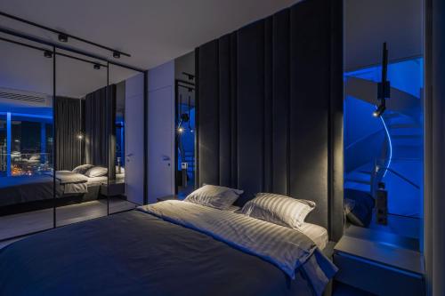 a bedroom with a large bed and a window at The Penthouse Kyiv in Kyiv