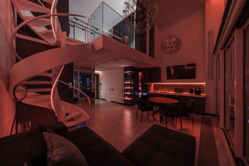 a spiral staircase in a living room with a table at The Penthouse Kyiv in Kyiv