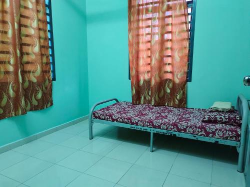 a bench in a room with red curtains at Homestay Pekan Pahang Semi D in Pekan