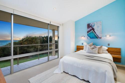 a bedroom with a bed and a large window at Swainson on Paruna in Port Adelaide