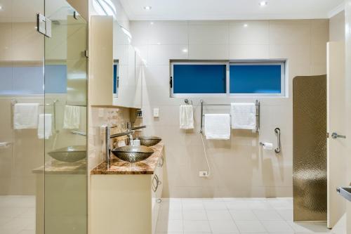 a bathroom with two sinks and a shower at Swainson on Paruna in Port Adelaide