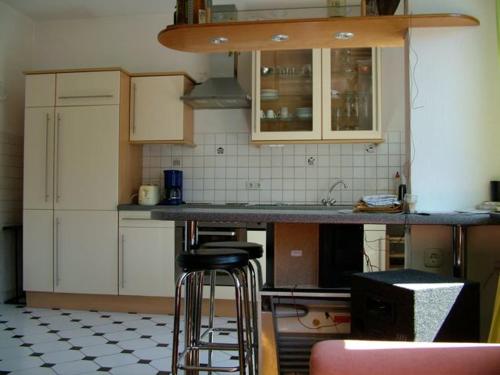 a kitchen with a counter and stools in it at Apartment am Friedrich Ebert Park mit über 100qm Wohnfläche in Hamm