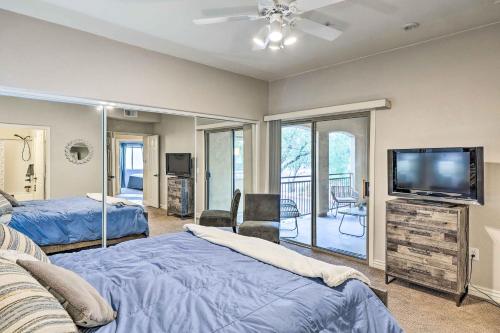 a bedroom with two beds and a flat screen tv at Pet-Friendly Scottsdale Condo with Pool Access! in Scottsdale