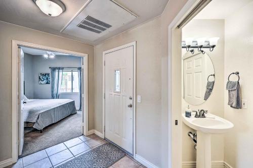 a bathroom with a sink and a bedroom with a bed at Pet-Friendly Scottsdale Condo with Pool Access! in Scottsdale