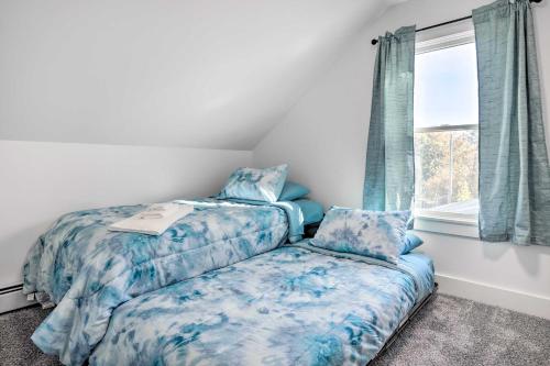 1 dormitorio con 2 camas y ventana en Cozy Historic Wakefield Home Close to Beaches en South Kingstown