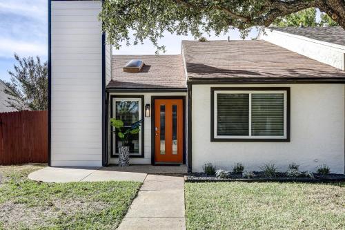 a house with a orange door and a yard at Stylish Allen Home near Watters Creek Village in Allen