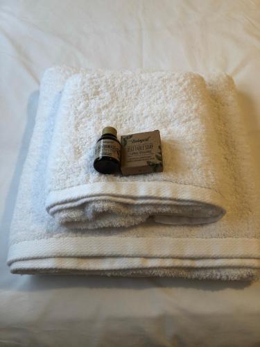 a pile of towels with a bottle of soap on them at Las Raucas in Colombres