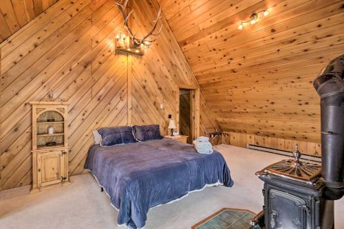 a bedroom with a bed in a wooden cabin at A-Frame Home with Breathtaking Views and Hot Tub! in Bozeman