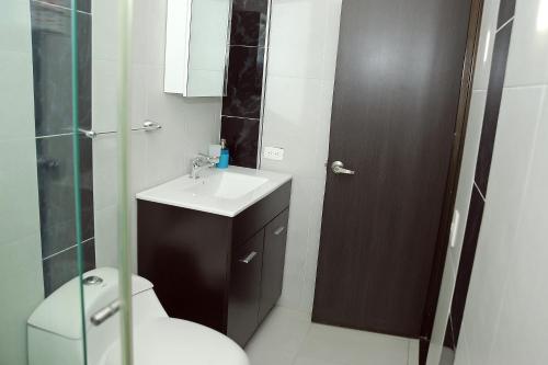 uma casa de banho com um WC, um lavatório e um chuveiro em Hotel Santo llanero em Palmira