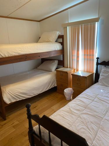 a bedroom with two bunk beds and a window at Edgewater Getaway in Port Lavaca