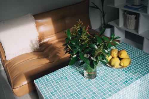 una mesa con un jarrón de flores y un plato de fruta en Amodiño do Camiño, en Belesar