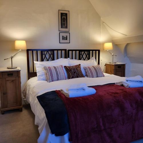 a bedroom with a large white bed with two lamps at Chapter House YORK in York