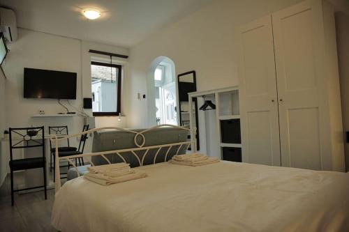 a bedroom with a large bed and a tv at Studio apartman Gajba in city center in Zagreb