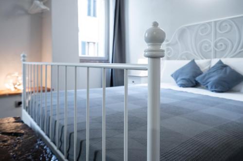 a bedroom with a bed with a white bed frame at A Casa di BiaGio in Rapolano Terme