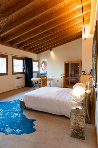 a bedroom with a large bed and a wooden ceiling at Locanda Sensi in Rivergaro