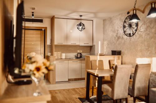 a kitchen and dining room with a table and chairs at NEO Apartman in Zlatibor