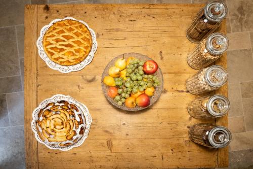a wooden table topped with plates of food and pies at A Casa di BiaGio in Rapolano Terme