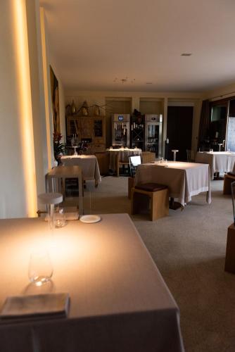 a large room with two tables and white tablesearcher at Locanda Sensi in Rivergaro