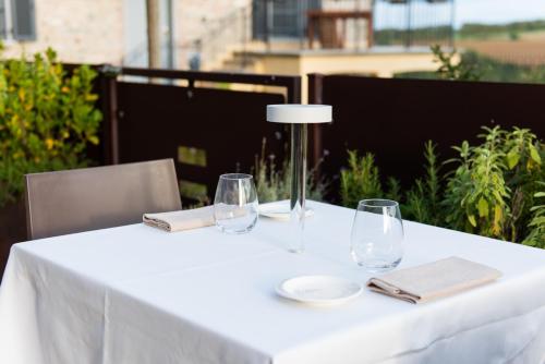 a white table with wine glasses and napkins at Locanda Sensi in Rivergaro
