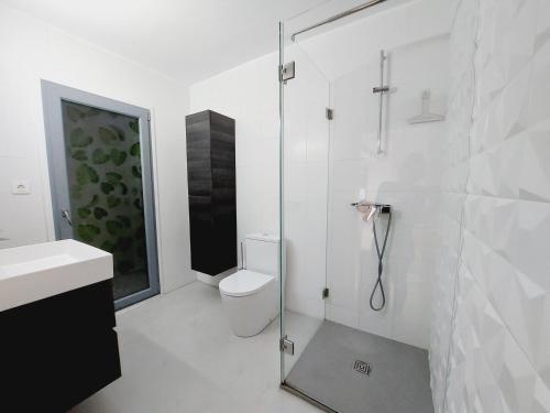 a bathroom with a toilet and a glass shower at Little love in Hospitalet de l'Infant