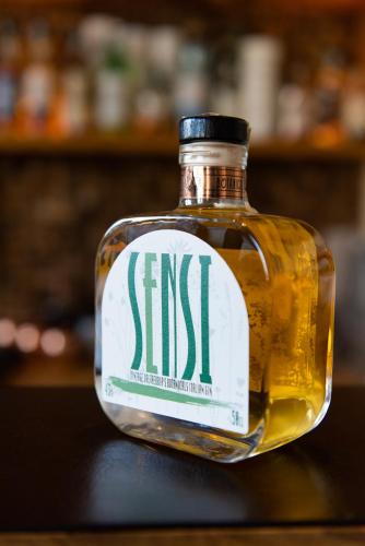a bottle of whiskey sitting on top of a table at Locanda Sensi in Rivergaro