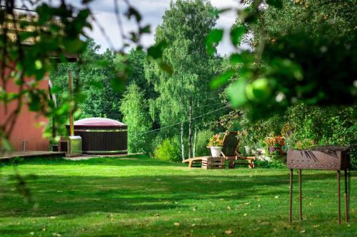 a park with a picnic table and a gazebo at Vēverkalni in Vidriži