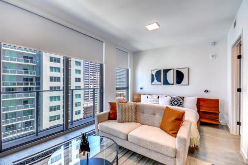 a living room with a couch and large windows at High end studio yotel downtown L57 in Miami