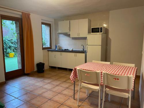a kitchen with a table and chairs and a refrigerator at Finca Son Guardiola in Llucmajor