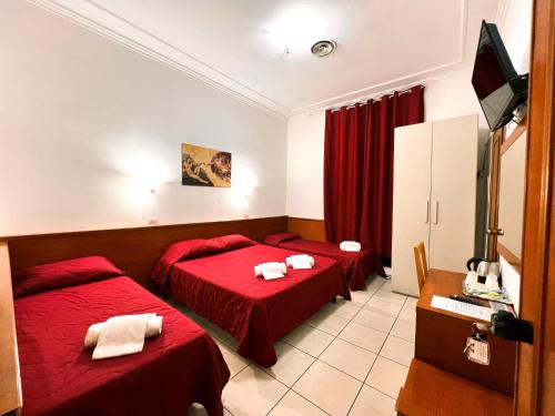 a hotel room with two beds and a television at Alius and Freerome Hotel in Rome